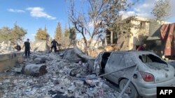 People check the destruction at the site of an Israeli airstrike that targeted the eastern village of Bazzaliyeh in the Hermel district of Lebanon's Bekaa valley, near the border with Syria, on November 1, 2024, amid the ongoing war between Israel and Hez