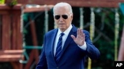 President Joe Biden waves to the media as he walks to board Marine One, July 15, 2024, on the South Lawn of the White House in Washington.