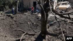 UKRAINE-RUSSIA-CONFLICT-WAR
27/140 characters
Local residents stand next to a crater and a destroyed residential house following a missile strike in Kyiv region, on Aug. 27, 2023, amid the Russian invasion of Ukraine. 