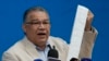 Former presidential candidate Enrique Marquez of the Centrados Party holds an election results tally sheet during a press conference about the disputed presidential election in Caracas, Venezuela, Aug. 14, 2024.