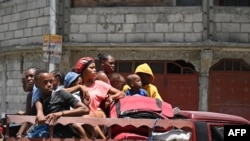 Residents evacuate the Carrefour Feuilles commune in Port-au-Prince, Haiti, on Aug. 15, 2023, as gang violence continues to plague the Haitian capital.