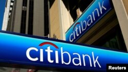 Foto Achiv: Moun mache anba yon afich branch Citibank nan San Francisco, Kalifoni, 17 Jiye, 2009. 