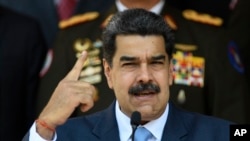 FILE - In this March 12, 2020 file photo, Venezuelan President Nicolas Maduro gives a press conference at the Miraflores presidential palace in Caracas, Venezuela. 