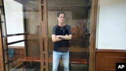 Wall Street Journal reporter Evan Gershkovich stands in a glass cage in a courtroom at the Moscow City Court in Moscow, Russia, June 22, 2023.