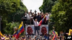 Opposition leader Maria Corina Machado holds a national flag while waving to supporters as she arrives for a rally in Caracas, Venezuela, Aug. 3, 2024.