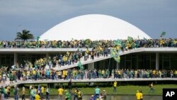 Protesters, supporters of Brazil's former President Jair Bolsonaro, storm the the National Congress building in Brasilia, Brazil, Jan. 8, 2023.