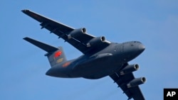 FILE - A Y-20 Chinese military transport plane is seen during an airshow in Zhuhai city, southern China, Nov. 7, 2018. Media and military experts said Sunday that six Chinese Y-20 planes landed in Belgrade Saturday, reportedly carrying surface-to-air miss