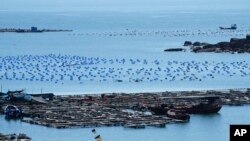 A boat moves through the water at the 68-nautical-mile scenic spot, the closest point in mainland China to the island of Taiwan, in Pingtan in southeastern China's Fujian province, Aug. 5, 2022.