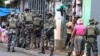 FILE PHOTO: A member of the Mozambique military, looks on as they patrol the streets of the capital a day after a "national shutdown" against the election outcome, in Maputo