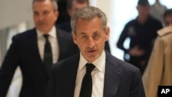 Former French President Nicolas Sarkozy arrives as he goes on trial over alleged illegal financing of his 2007 presidential campaign by the government of late Libyan leader Moammar Gadhafi, Jan. 6, 2025 in Paris. 