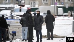 Investigators gather by a body at the blast scene, which killed Lieutenant General Igor Kirillov, and his assistant, according to the Russian Investigative Committee, in Moscow, Dec. 17, 2024. 