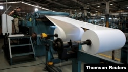 FILE PHOTO: A worker preps the role prior to running the presses in the La Prensa newspaper printing plant in Managua