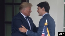 (FILES) US Presidnt Donald Trump greets Canadian Prime Minister Justin Trudeau at the White House in Washington, DC, on June 20, 2019.