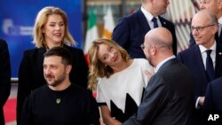 European Council President Charles Michel, 2nd right, talks to Italy's Prime Minister Giorgia Meloni, center, Ukraine's President Volodymyr Zelenskyy, bottom left, as they arrive for a group photo during an EU summit in Brussels, Oct. 17, 2024. 