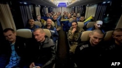 This handout photograph released by the official Telegram channel of Ukrainian President Volodymyr Zelensky on December 30, 2024, shows some of the 189 Ukrainian prisoners of war, after an exchange at an undisclosed location, amid the Russian invasion in 