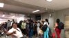 Cuban tourists line up to board their flight at the Toussaint Louverture airport in Port-au-Prince, Haiti. (S. Lemaire/VOA) 