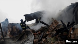 Firefighters work at the site of residential buildings hit by a Russian drone strike in Kharkiv, Ukraine, Dec. 25, 2024.