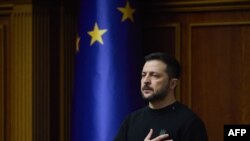 TOPSHOT - In this handout photograph taken and released by the Ukrainian Presidential Press Service on November 19, 2024, Ukraine's President Volodymyr Zelensky listens to Ukraine's national anthem prior to his address to members of the Ukrainian parliame