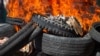 Bodies of alleged gang members covered in tires burn in the street in Petion-Ville, a suburb of Port-au-Prince, Haiti, Nov. 19, 2024. Police and civilian self-defense groups killed 28 alleged gang members in the Port-au-Prince, authorities said Tuesday, 