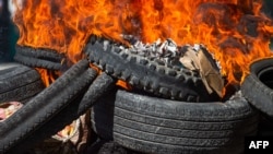 Bodies of alleged gang members covered in tires burn in the street in Petion-Ville, a suburb of Port-au-Prince, Haiti, Nov. 19, 2024. Police and civilian self-defense groups killed 28 alleged gang members in the Port-au-Prince, authorities said Tuesday, 