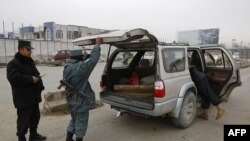 Cảnh sát Afghanistan khám xét xe cộ tại một chốt kiểm soát ở Kabul, ngày 26/2/2012