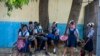 Student wait their turn to enter Lycee Marie Jeanne school on first day of school since the COVID-19 pandemic in Port-au-Prince, Haiti, Monday, Aug. 17, 2020. (AP Photo/Dieu Nalio Chery)