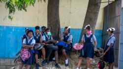 Student wait their turn to enter Lycee Marie Jeanne school on first day of school since the COVID-19 pandemic in Port-au-Prince, Haiti, Monday, Aug. 17, 2020. (AP Photo/Dieu Nalio Chery)