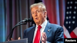 FILE PHOTO: US President-elect Donald Trump attends a meeting with House Republicans at the Hyatt Regency hotel in Washington