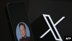 This illustration photograph shows the logo of social network X (formerly Twitter) and a photograph of CEO of social network X, Elon Musk displayed on a smartphone in Brussels on September 27, 2024. (Photo by Nicolas TUCAT / AFP)