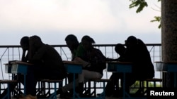 Students study in a school courtyard in Port-au-Prince September 20, 2011. Haitian President Michel Martelly announced during his trip to New York, to attend the U.N. General assembly, that key mandates for the reconstruction of his country is education a