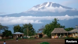 Houses sit at the foot of Mount Kilimanjaro in Tanzania's Hie district.