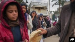 Palestinian women and children queue for bread in Deir al-Balah, Gaza Strip, Nov. 28, 2024.