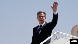 U.S. Secretary of State Antony Blinken waves as he boards a plane leaving Riyadh, Saudi Arabia, on October 15, 2023.