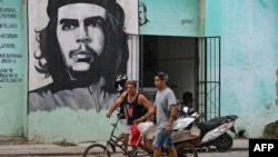 Cubans walk in a street of Havana, on January 14, 2025.