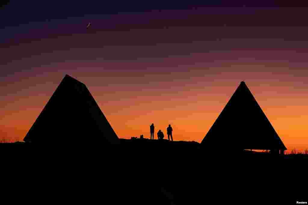 Tourists watch the sunset in the Caucasus mountains outside Krasnaya Polyana near Sochi, Russia.