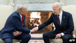 US President Joe Biden shakes hands with US President-elect Donald Trump during a meeting in the Oval Office of the White House in Washington, DC, on November 13, 2024.